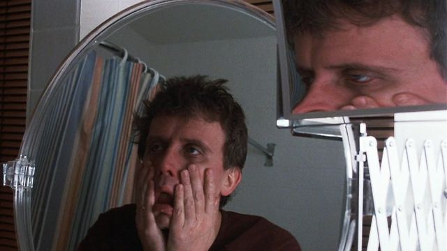 Bart Hughes (Peter Weller) faces off against a rodent foe in Of Unknown Origin (1983).